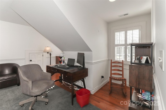 office space with wood finished floors, visible vents, and baseboards