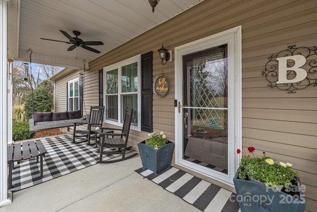 property entrance featuring a porch and ceiling fan