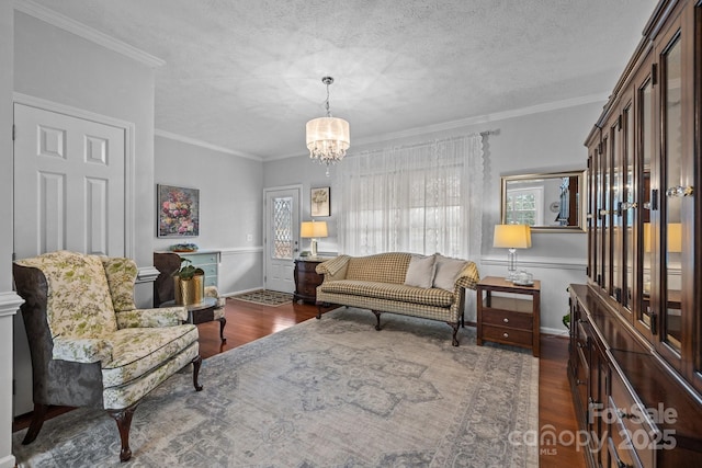 living room featuring plenty of natural light, a textured ceiling, wood finished floors, and crown molding