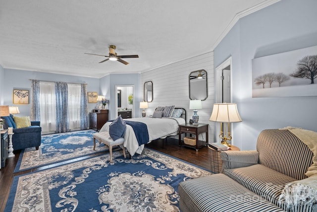 bedroom featuring ornamental molding, a textured ceiling, ceiling fan, and wood finished floors