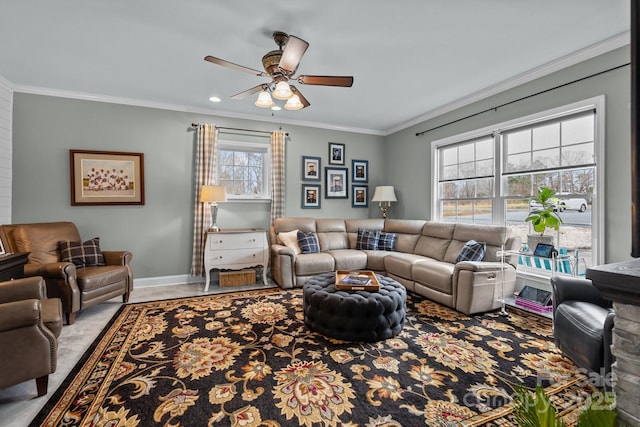 living room featuring baseboards, ornamental molding, and a ceiling fan