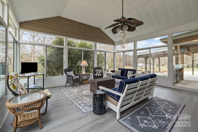 sunroom featuring a ceiling fan and lofted ceiling