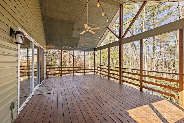 unfurnished sunroom with lofted ceiling and ceiling fan