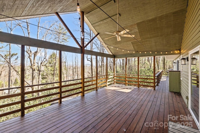 wooden deck featuring ceiling fan