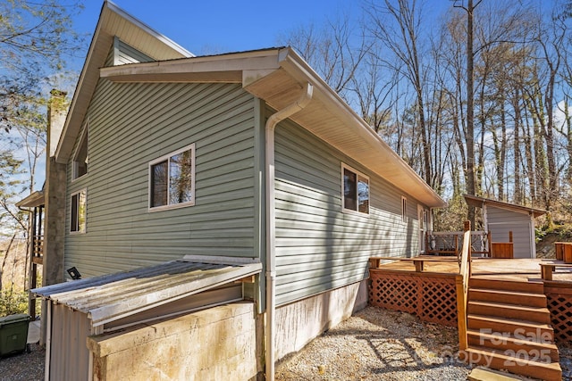 view of home's exterior with a wooden deck