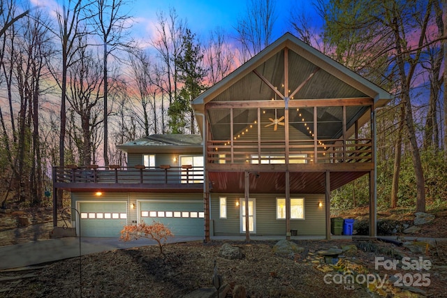 view of front of home featuring driveway and a wooden deck