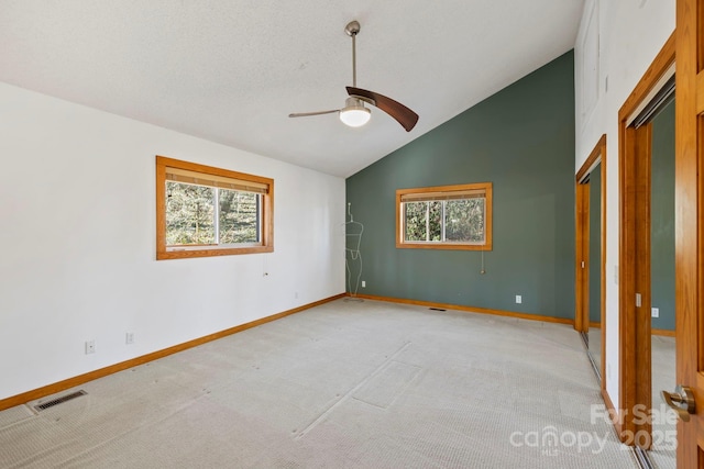 unfurnished bedroom with light carpet, baseboards, multiple windows, and visible vents