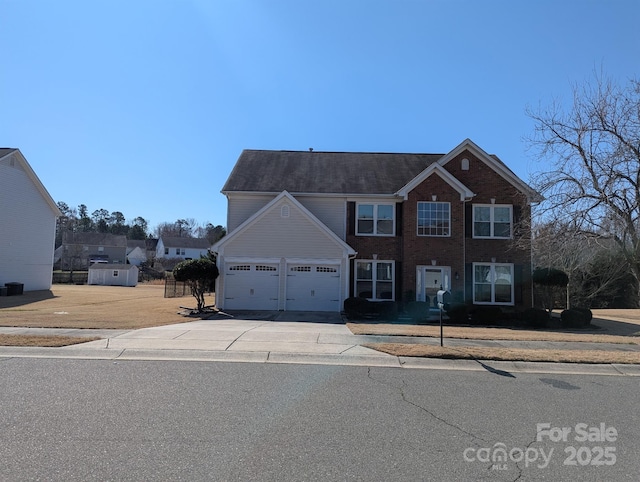 view of front facade featuring driveway, a garage, and brick siding