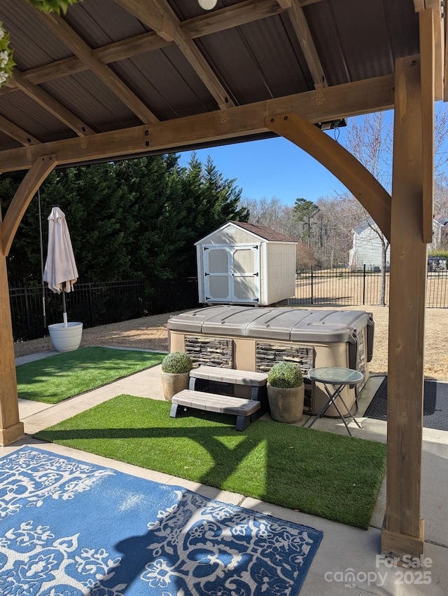 view of patio / terrace with a storage unit, an outdoor structure, and fence private yard