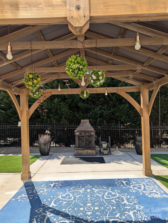 exterior space featuring a patio, a gazebo, and fence