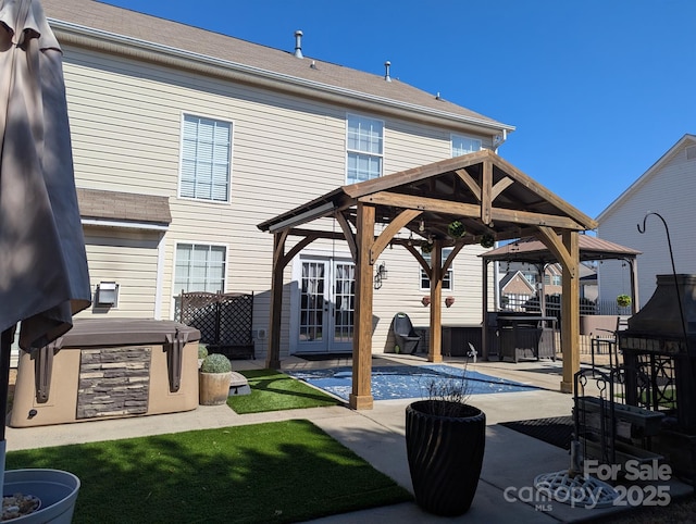 exterior space with french doors, a patio, a hot tub, and a gazebo