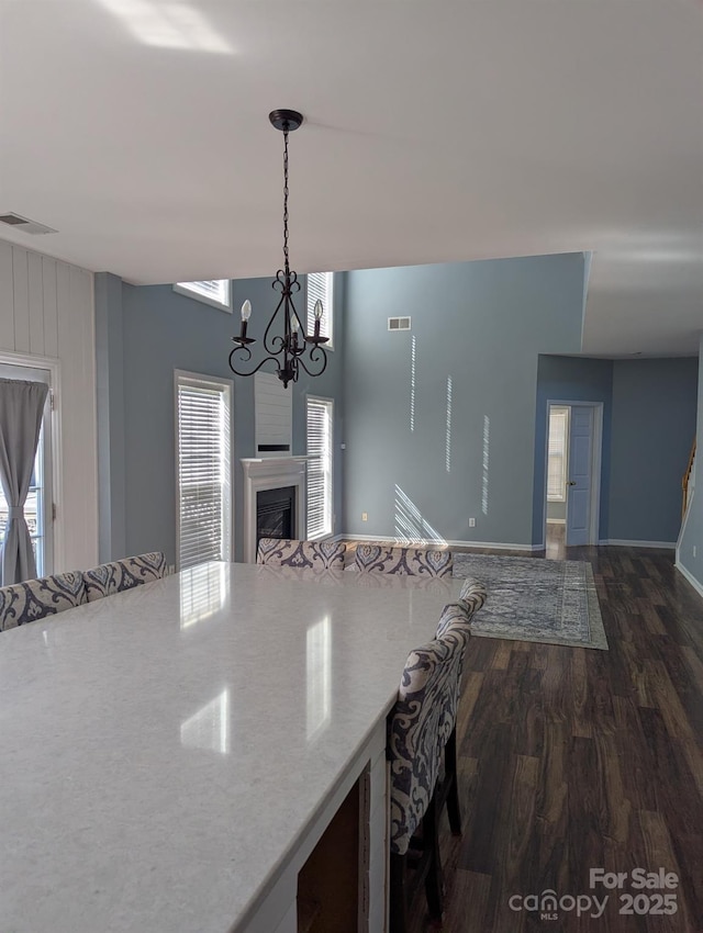 kitchen featuring a fireplace, visible vents, dark wood finished floors, and open floor plan