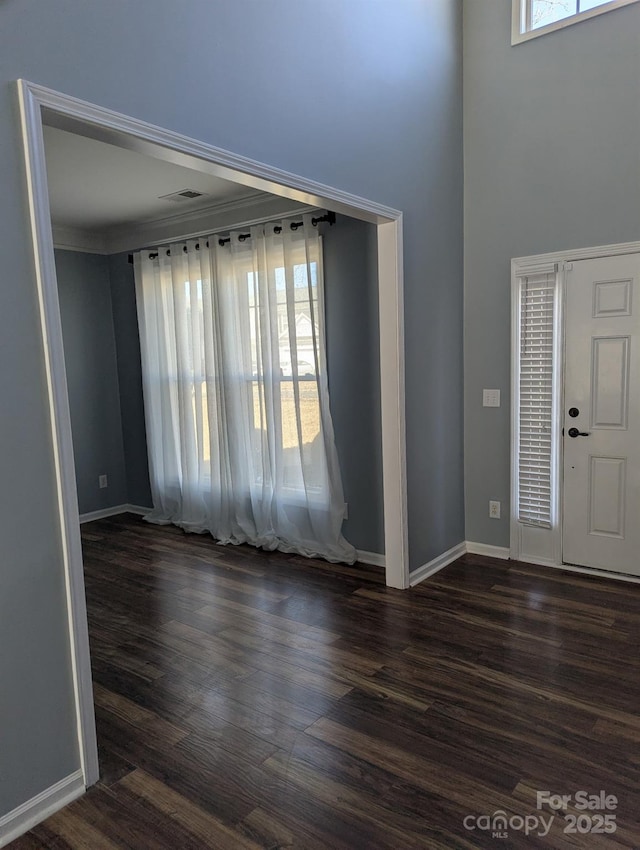 entryway featuring visible vents, baseboards, and wood finished floors