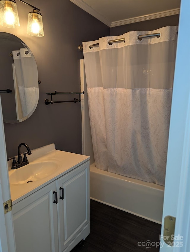 bathroom with ornamental molding, wood finished floors, shower / bath combination with curtain, and vanity