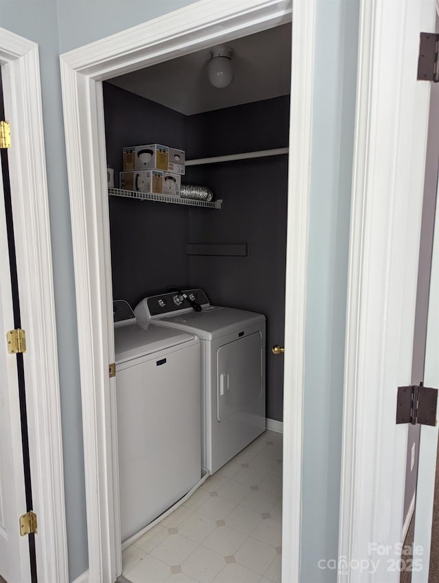 laundry area with laundry area, light floors, and washer and dryer