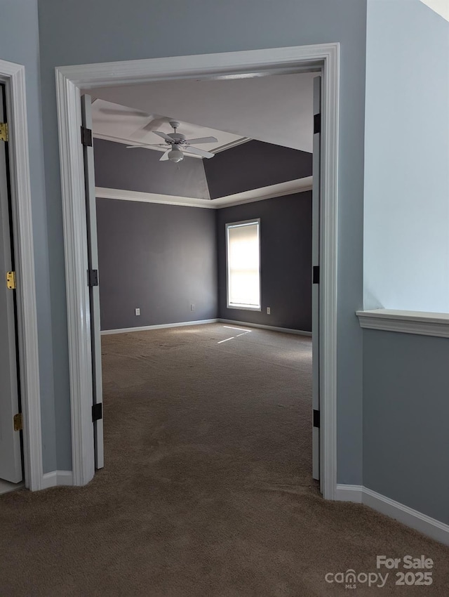 unfurnished room with lofted ceiling, carpet, a ceiling fan, and baseboards