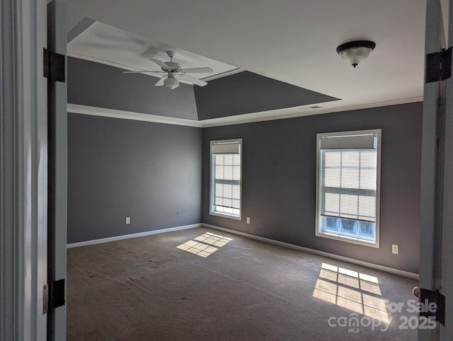 empty room with ceiling fan, ornamental molding, carpet, and baseboards