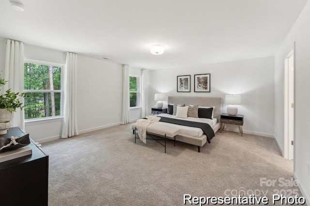 carpeted bedroom featuring baseboards