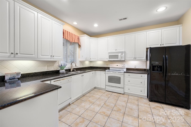 kitchen featuring visible vents, a sink, white cabinetry, white appliances, and light tile patterned floors