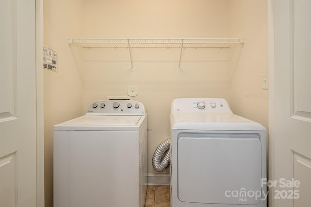 clothes washing area with washing machine and clothes dryer and laundry area