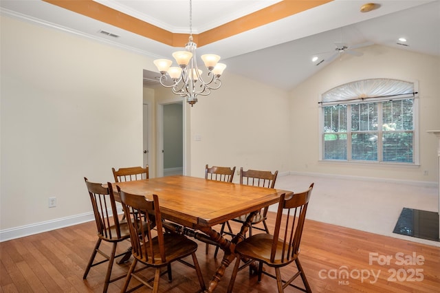 dining room with visible vents, crown molding, baseboards, ceiling fan with notable chandelier, and wood-type flooring