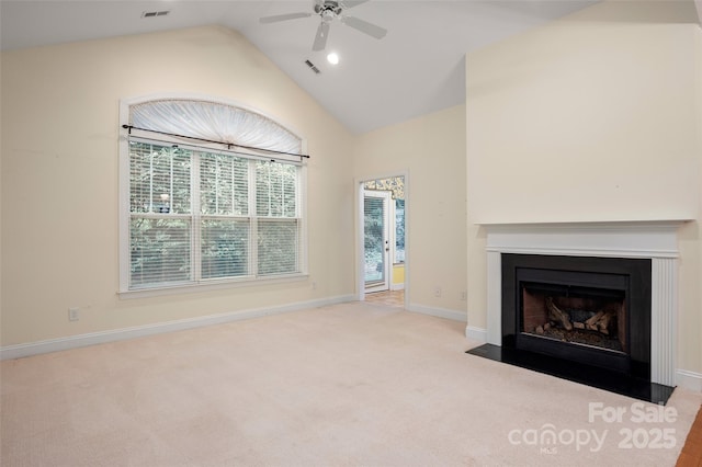 unfurnished living room with carpet flooring, lofted ceiling, a fireplace with flush hearth, and visible vents