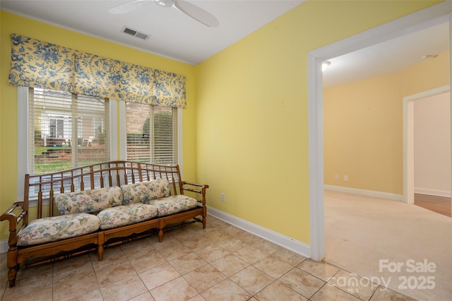 sitting room featuring visible vents, baseboards, ceiling fan, light carpet, and light tile patterned flooring