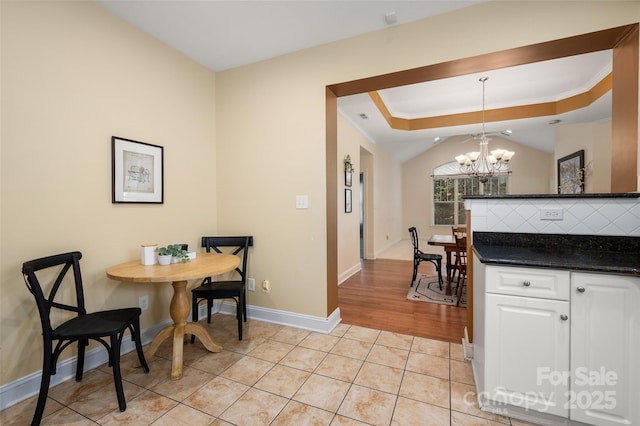 dining room with light tile patterned floors, baseboards, a chandelier, and crown molding