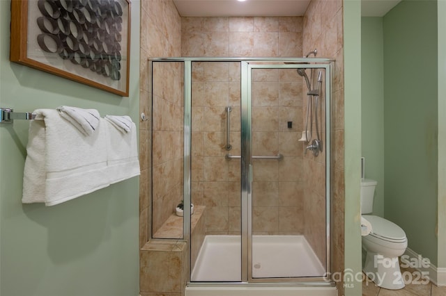 full bathroom with a shower stall and toilet