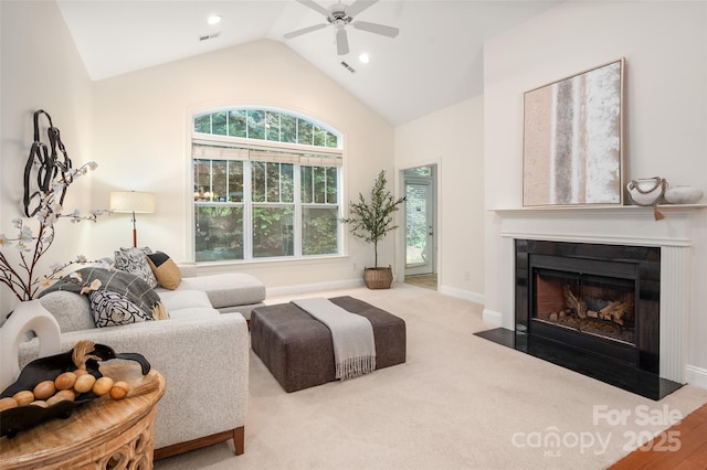 carpeted living area with recessed lighting, ceiling fan, baseboards, visible vents, and a fireplace with flush hearth