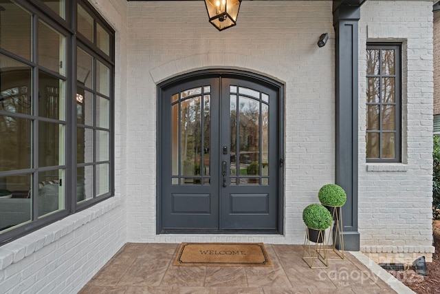 property entrance with french doors and brick siding