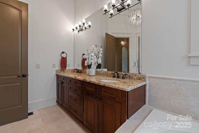 bathroom with double vanity, a washtub, and a sink