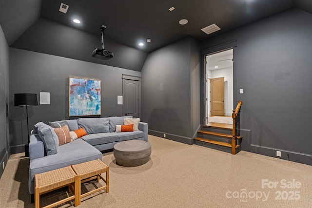 home theater room with lofted ceiling, recessed lighting, and visible vents