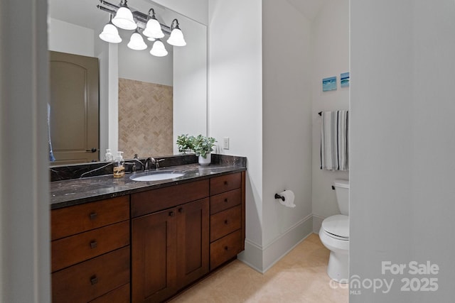 bathroom featuring tile patterned flooring, toilet, vanity, and baseboards