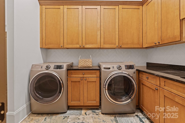 clothes washing area with cabinet space and washer and clothes dryer