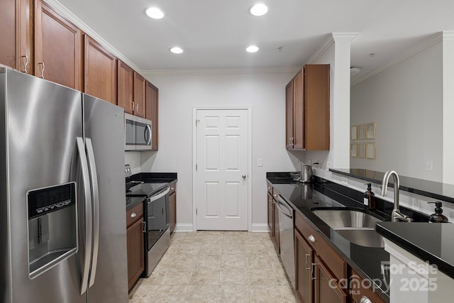 kitchen featuring dark countertops, stainless steel appliances, crown molding, a sink, and recessed lighting