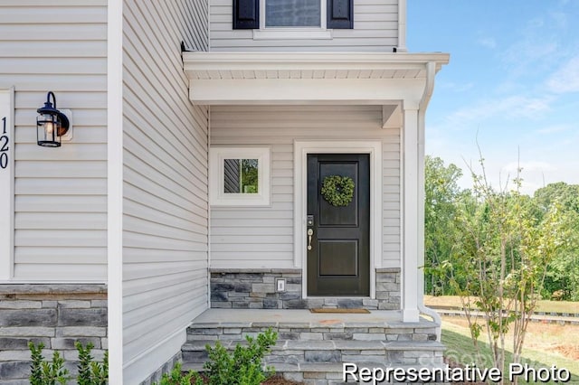 view of exterior entry with stone siding