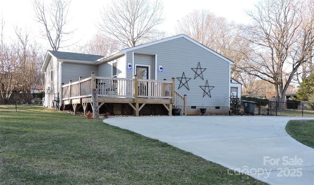 rear view of house featuring crawl space, a wooden deck, fence, and a yard