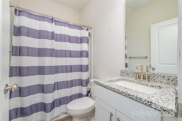 bathroom with toilet, a shower with curtain, and vanity