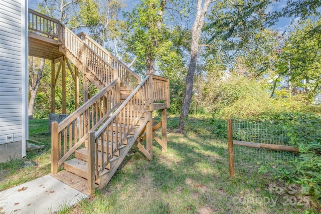 view of yard with fence, stairway, and a deck