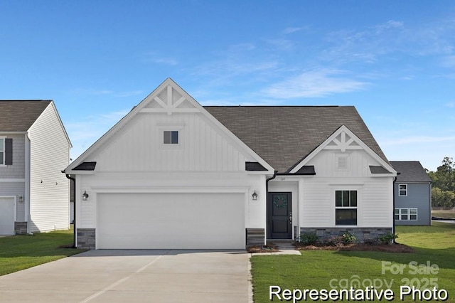 view of front facade featuring an attached garage, board and batten siding, stone siding, driveway, and a front lawn