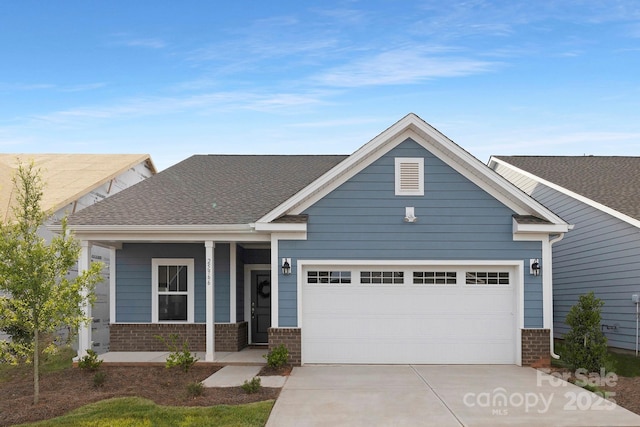 25966 Appleyard Ct Unit 1205, Lancaster, SC 29720 - view of front of house featuring brick siding, driveway, a garage, and a porch