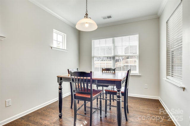 dining space with baseboards, crown molding, visible vents, and dark wood-type flooring