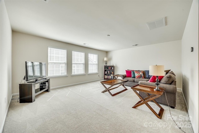 living room with baseboards, visible vents, and light colored carpet