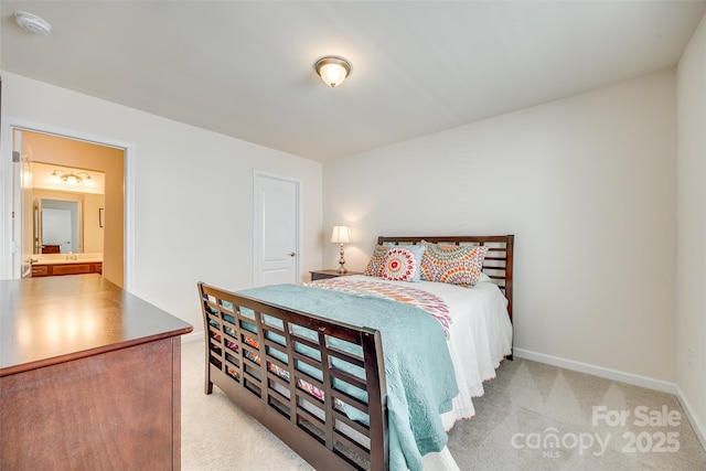 bedroom with baseboards and light colored carpet