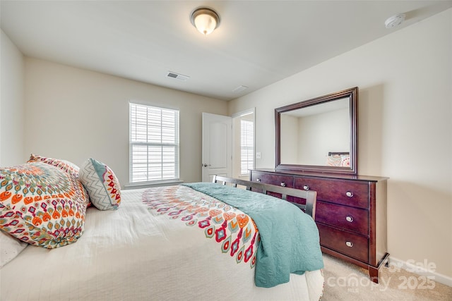 bedroom featuring carpet floors, visible vents, and baseboards