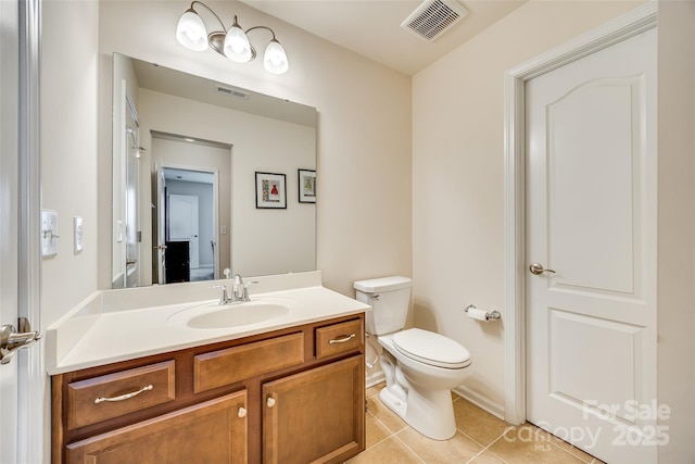 bathroom featuring toilet, vanity, visible vents, and tile patterned floors