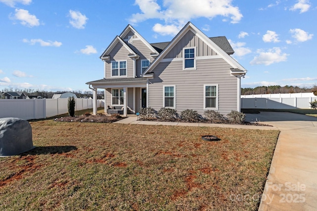 view of front facade featuring a porch, a front lawn, fence, and board and batten siding