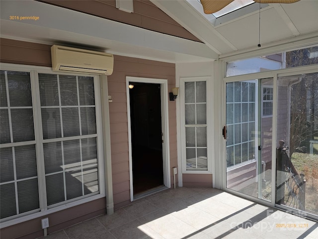 unfurnished sunroom featuring vaulted ceiling and a wall mounted AC