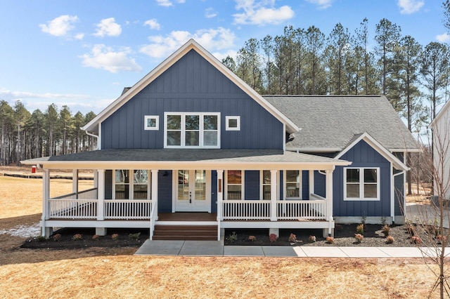 view of front of property featuring covered porch, board and batten siding, and roof with shingles